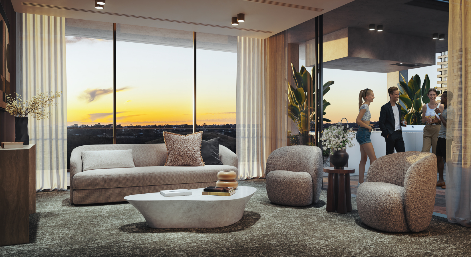 The Wentworth Quarter resident lounge with a golden sunset in the background. A seating area with plush lounges and chairs open onto a terrace kitchen bench.