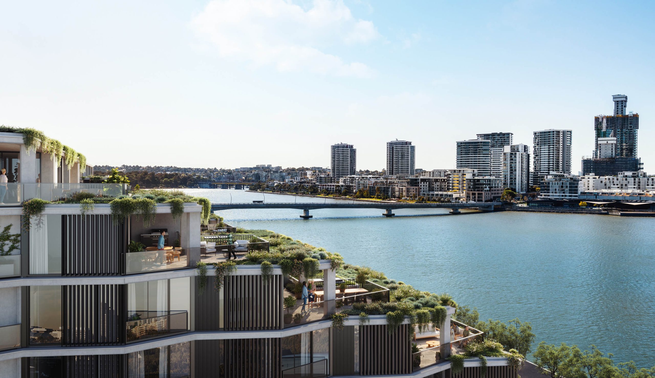 View over the top of Wentworth Quarter, looking to Homebush Bay and Rhodes. The visible apartments feature indoor-outdoor living spaces with lush planting.