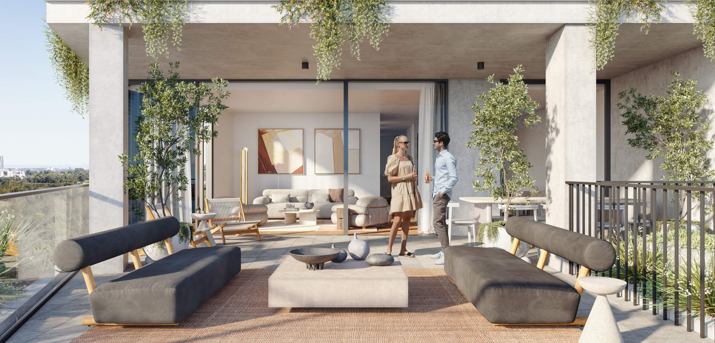 An individual apartment balcony, featuring stylish outdoor furniture and lush planting. The interior living space is visible through the clear glass door and full-length window.